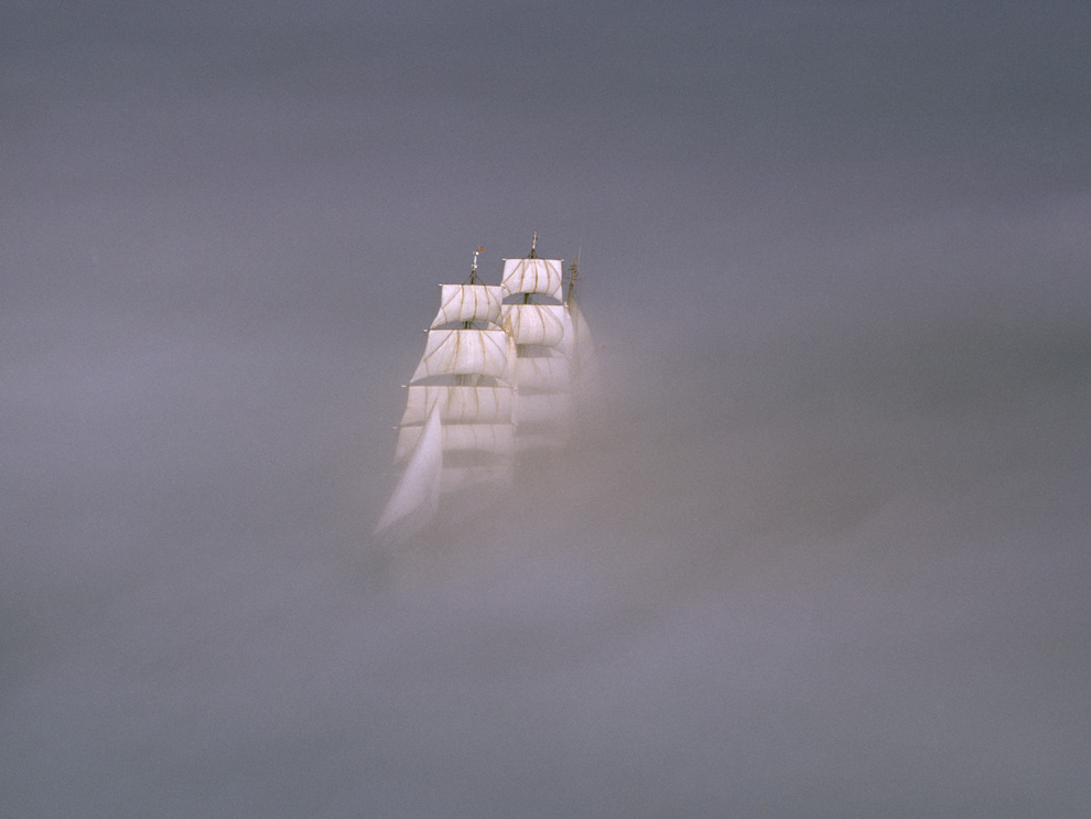 Sailing ship obscured in a thick fog.